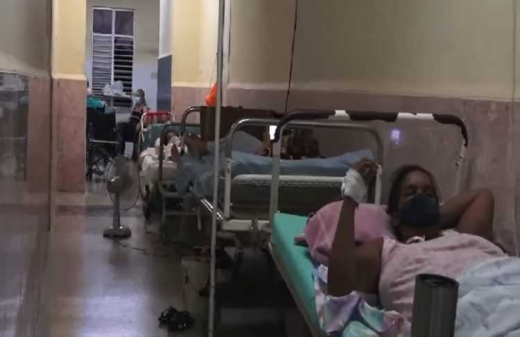 people in rusted beds in a hospital in Cuba